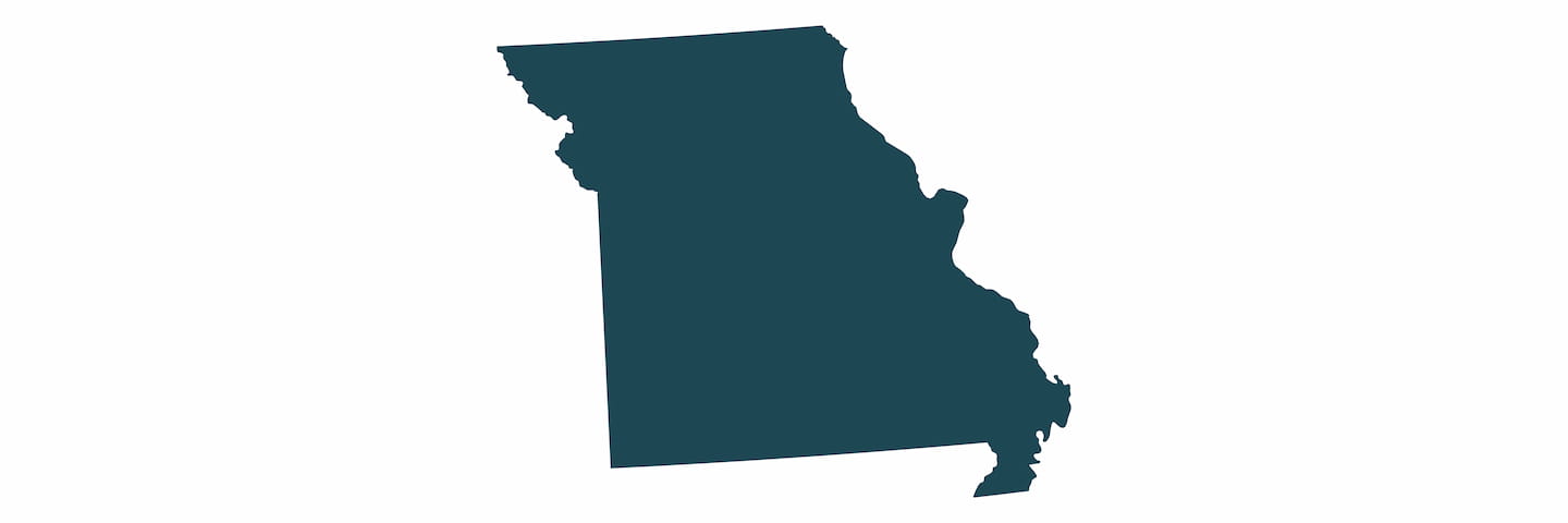 Simple dark silhouette of the state of Missouri on a plain white background.