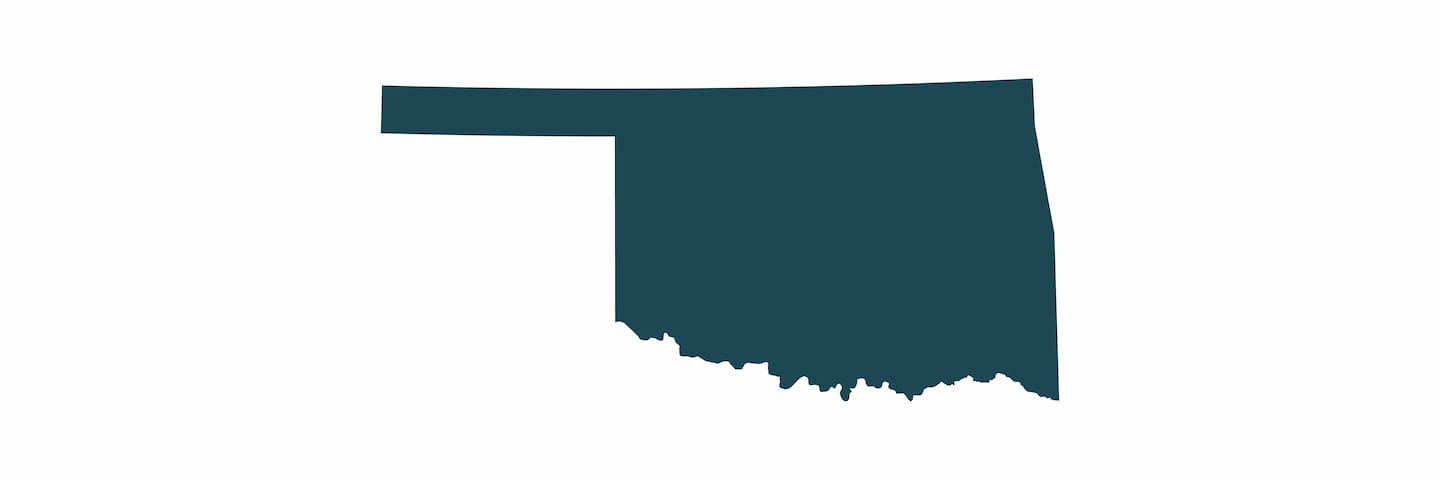 A simple graphic depiction of the state of Oklahoma's silhouette in a solid dark teal color against a white background.